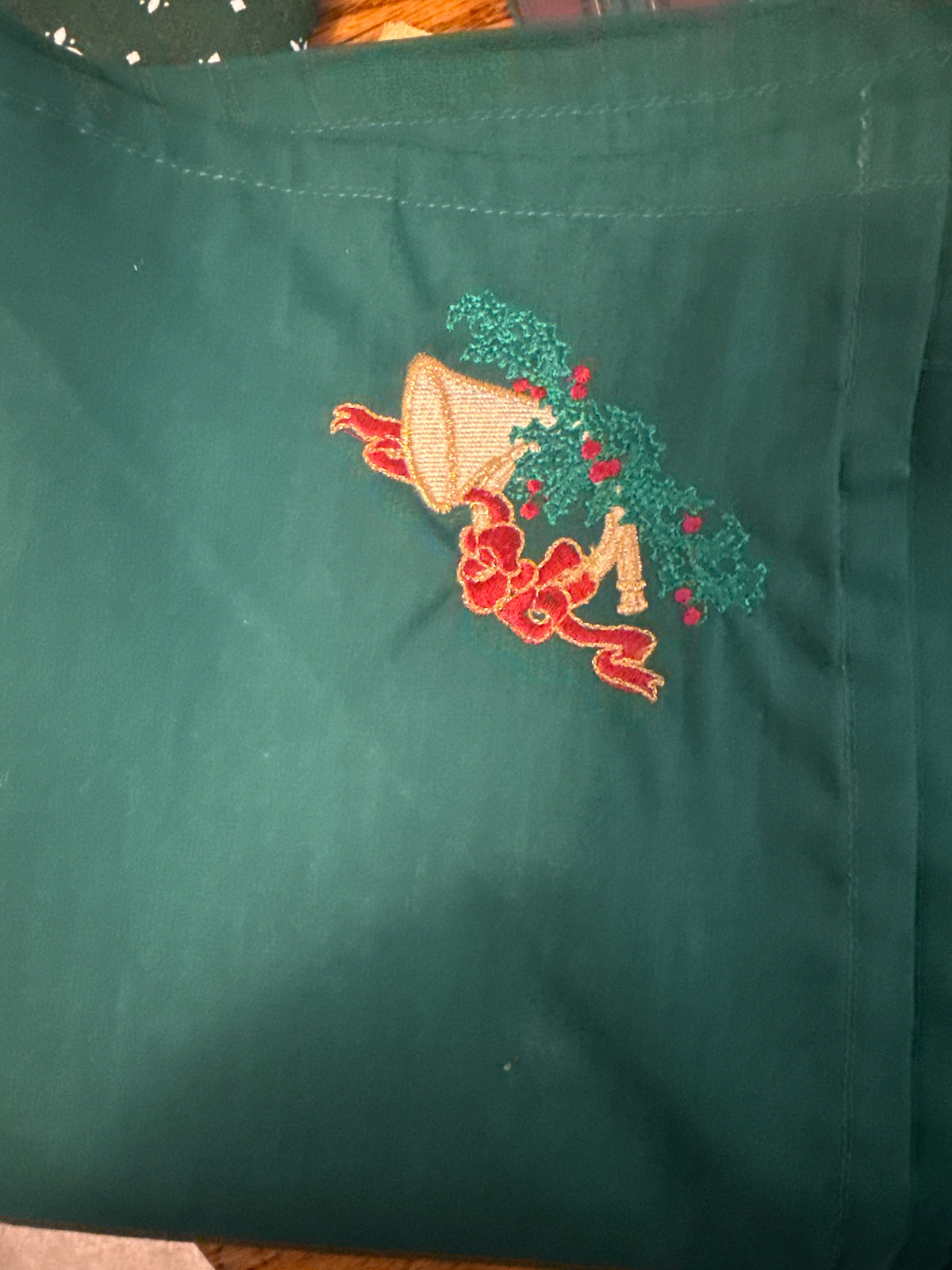 Homestead 36x36 Ivy table square with Christmas bell embroidered design on one end