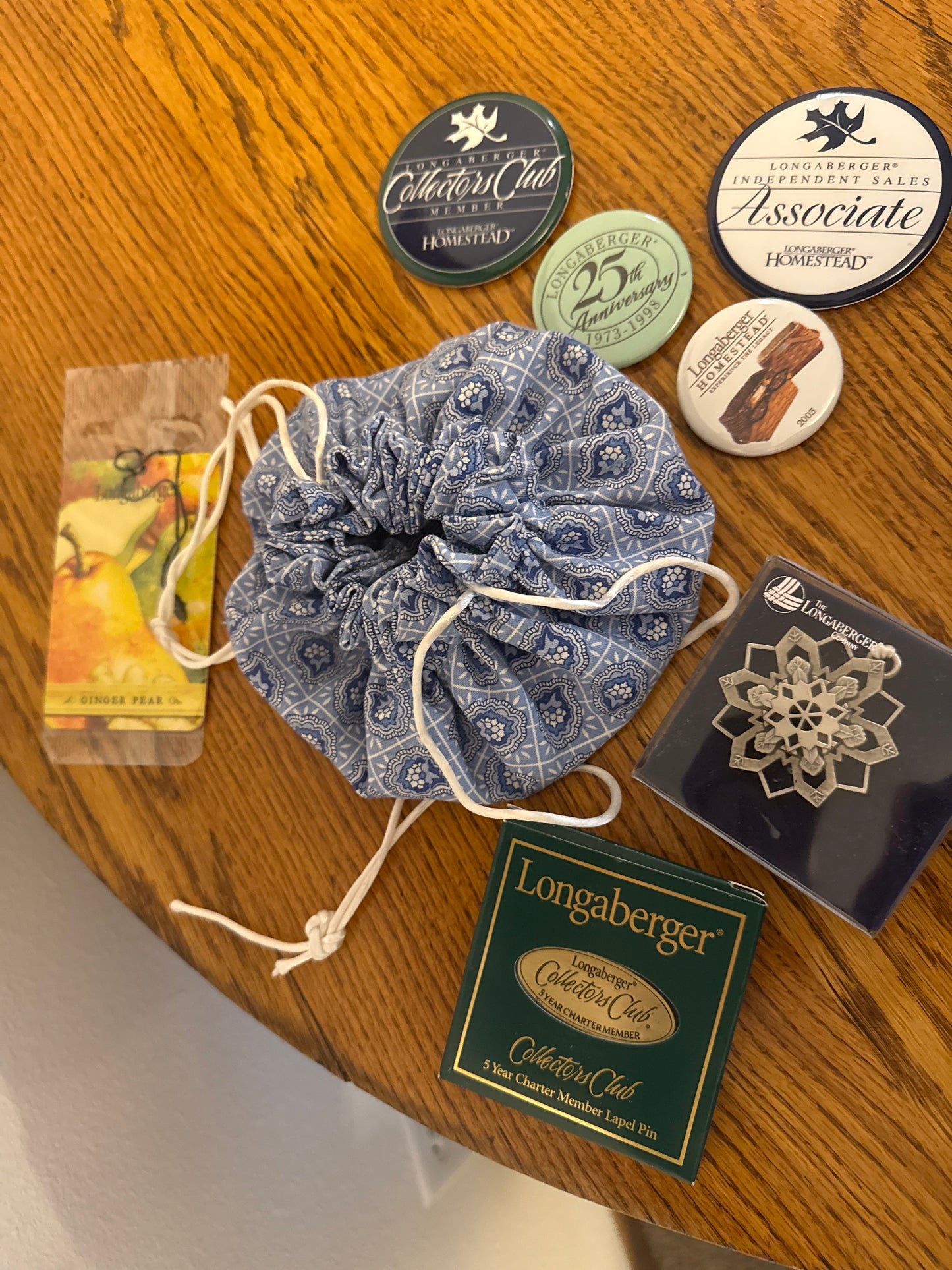 Longaberger items sold as a lot (provincial jewelry bag, pewter snowflake ornament, various pins)