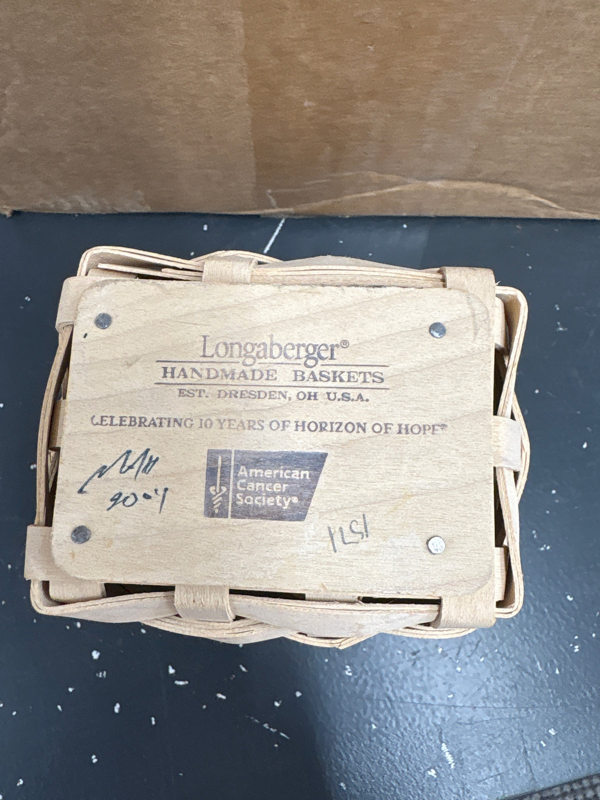 Longaberger 2004 Horizon of Hope Basket with Protector and Tie on in White Wash. A few metal marks on front.