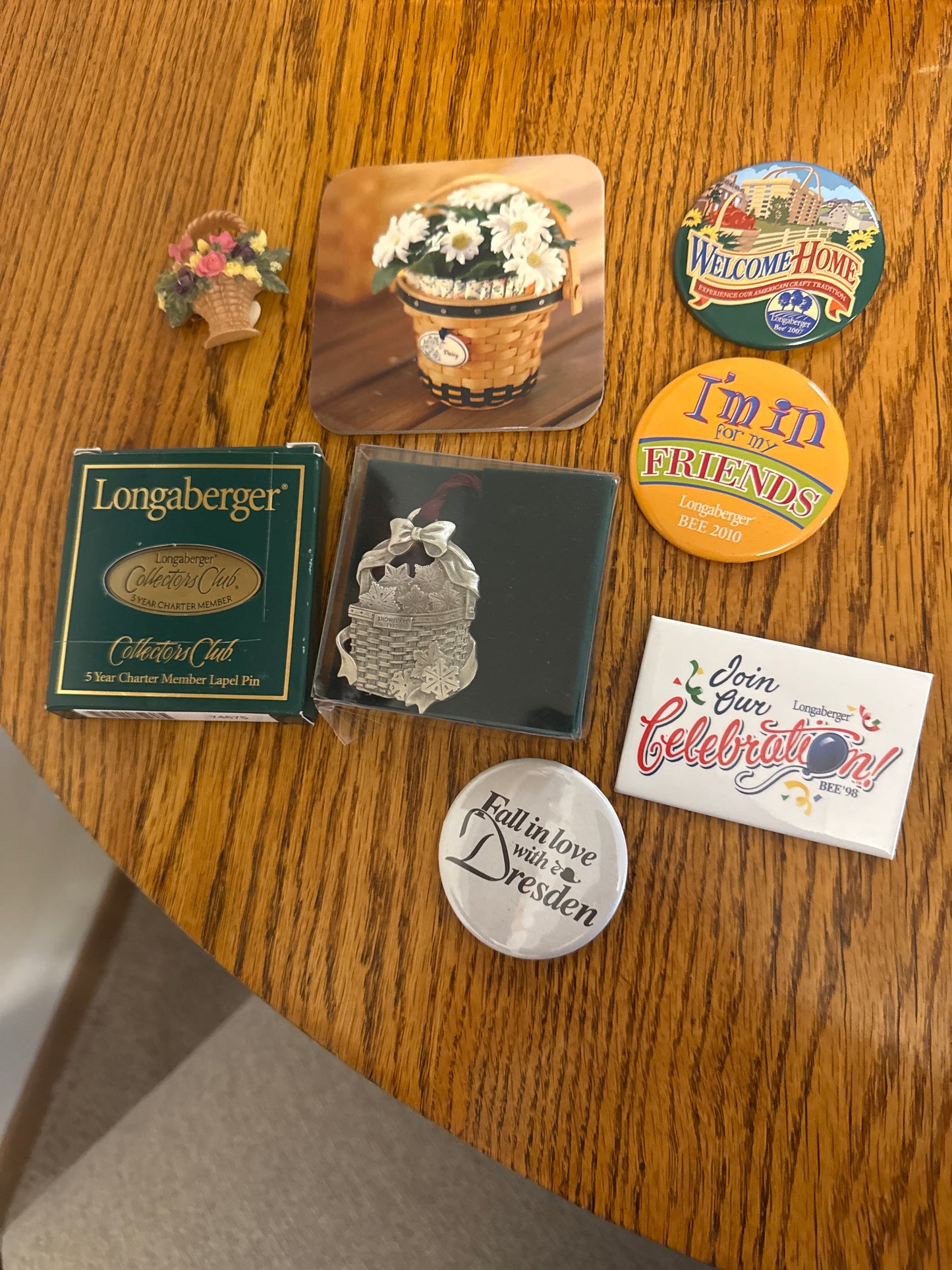 Longaberger and homestead items sold as a lot (pewter ornament, daisy coaster, flower magnet, various pins)