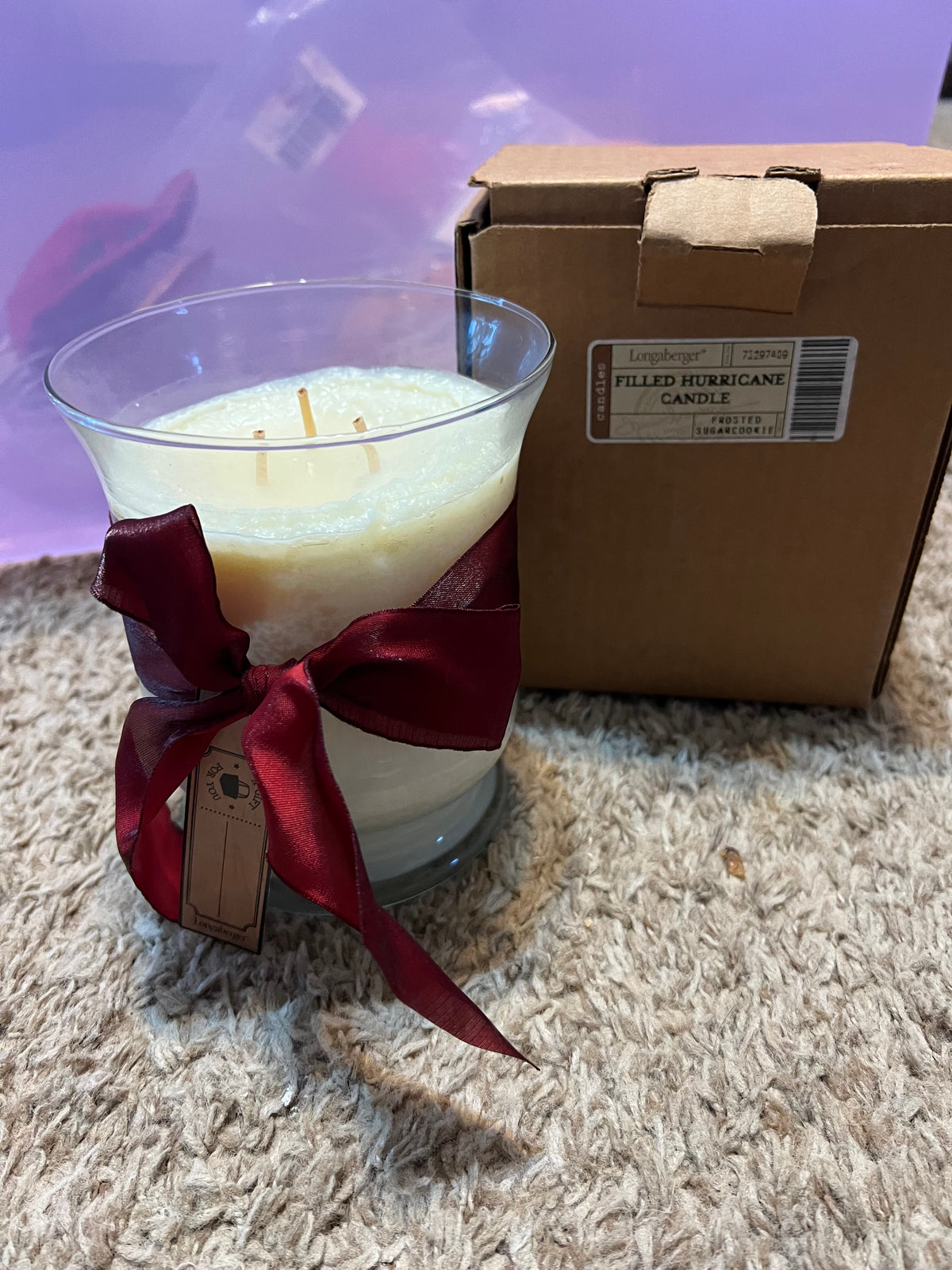 Longaberger filled hurricane candle jar in frosted sugar cookie