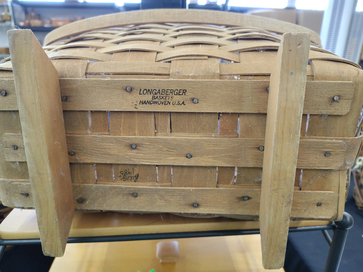 Longaberger footed magazine basket  Leans forward and dusty