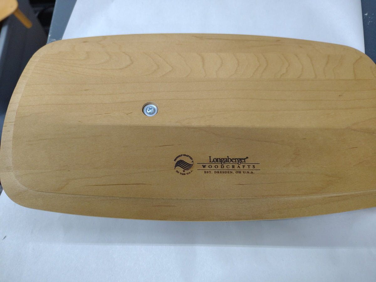 Longaberger wrap it up lid.  Has scratch on green stripe