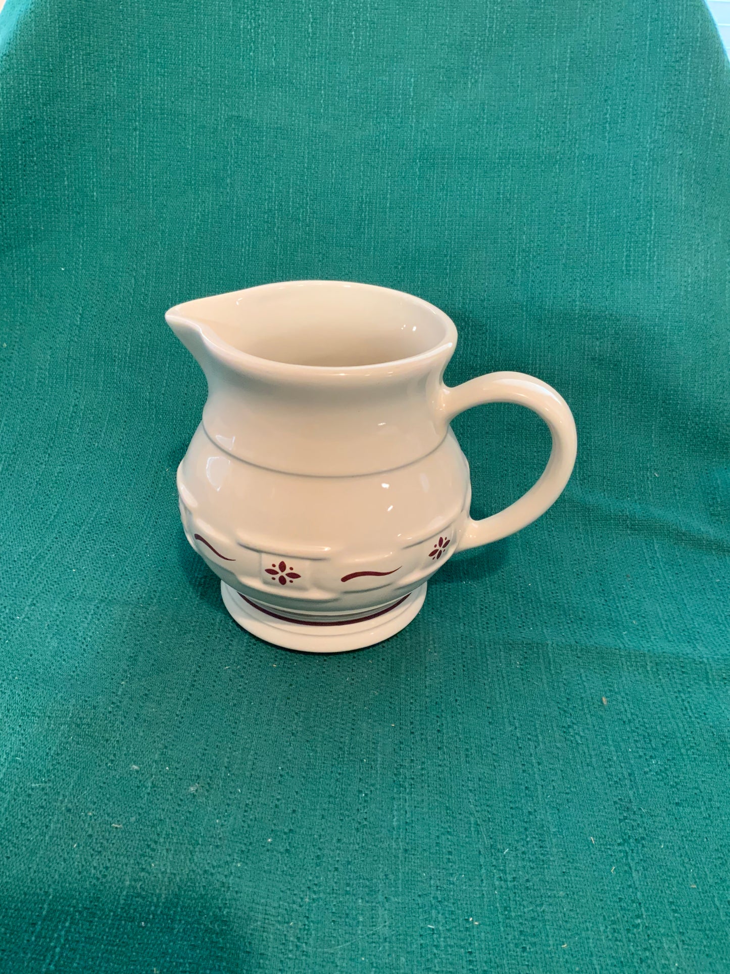 Longaberger 2 quart milk pitcher in traditional red